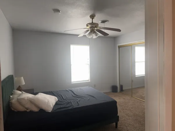 a bedroom with a bed and a window