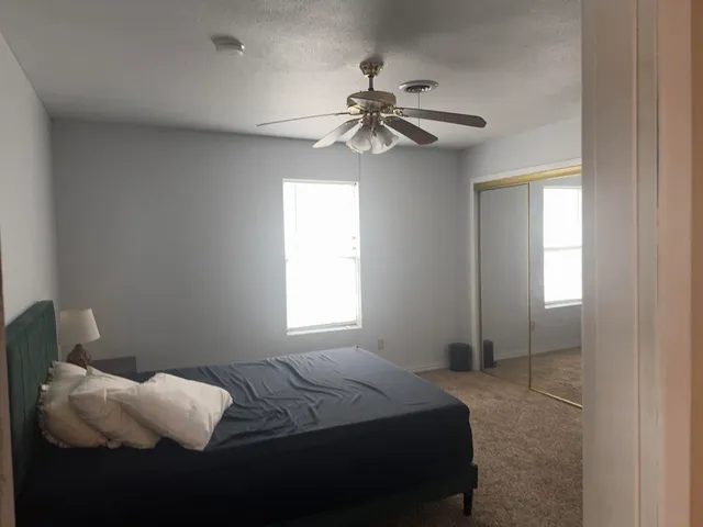 a bedroom with a bed and a window