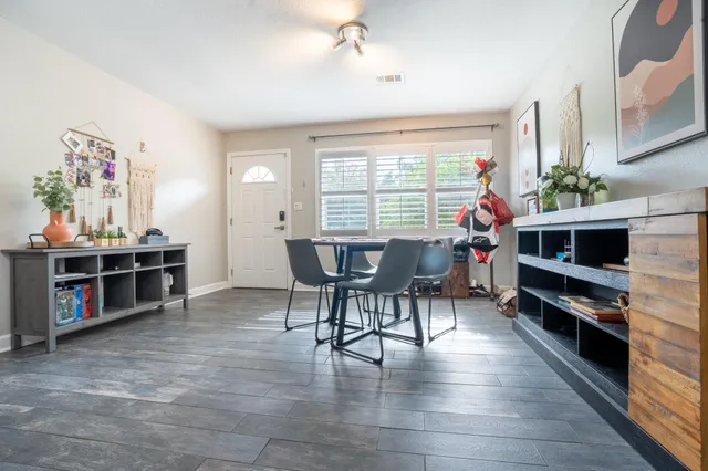 a view of a dining room with furniture and a flat screen tv