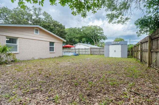 a backyard of a house with table and chairs