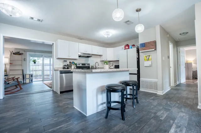 a kitchen view with stainless steel appliances furniture refrigerator and cabinets