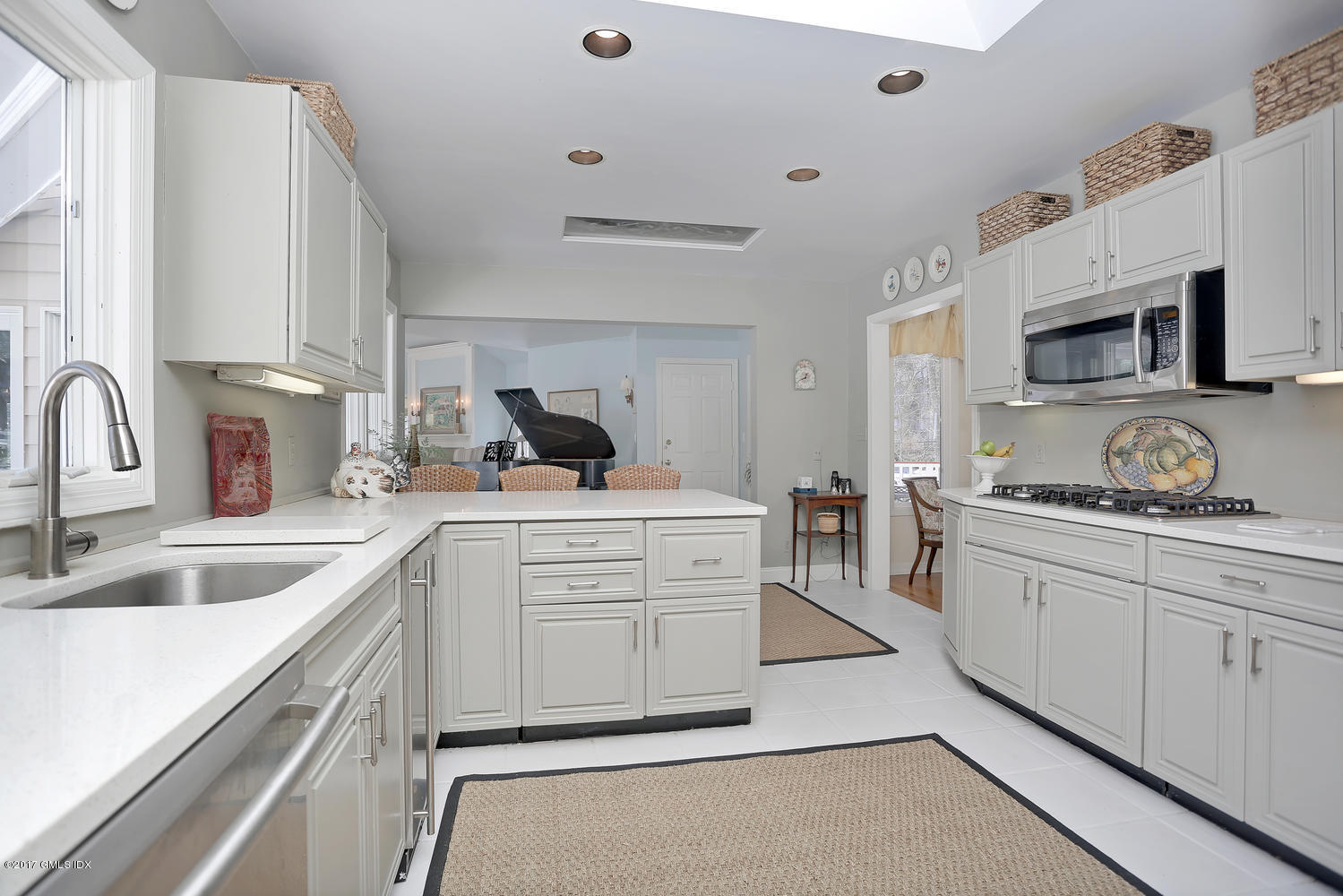 14 Weston Hill Road Riverside, CT 06878 - Photo 6 of 18 a kitchen with white cabinets a sink and appliances