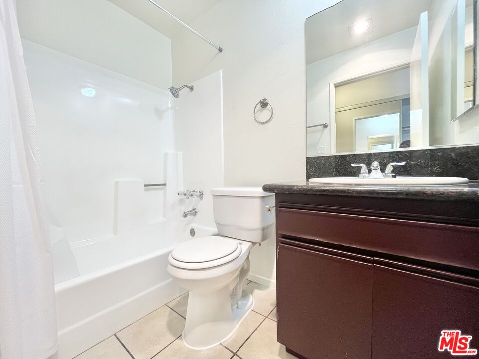 8722 Burton Way, Unit 102 Los Angeles, CA 90048 - Photo 8 of 11 a bathroom with a sink toilet and shower