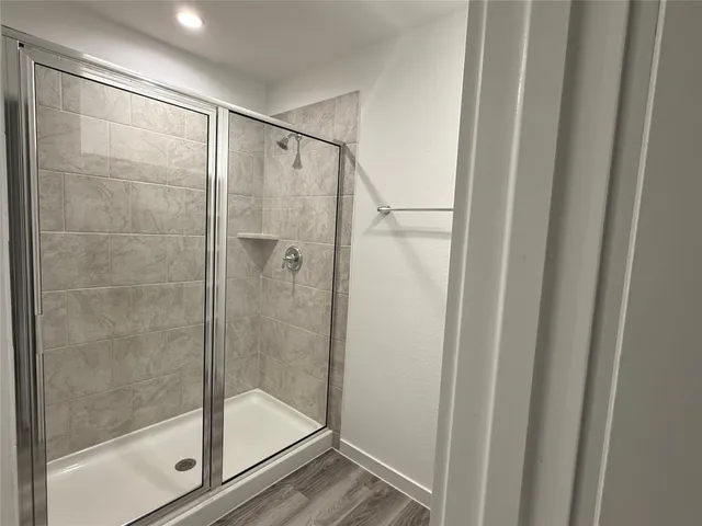 a bathroom with a sink a mirror and a shower