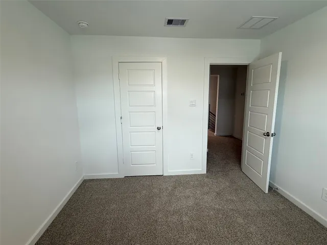 an empty room with closet area