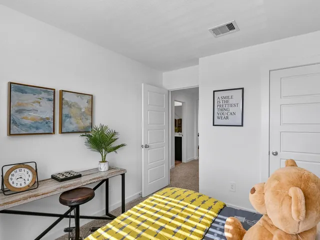 a bedroom with a bed and a potted plant