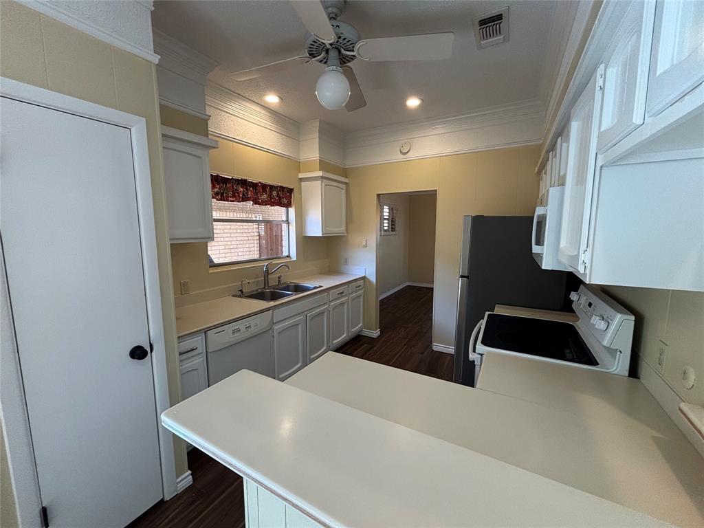 4702 Ranch View Road Fort Worth, TX 76109 - Photo 13 of 40 Kitchen featuring white cabinetry, light-toned countertops, a ceiling fan, and wood-finish flooring