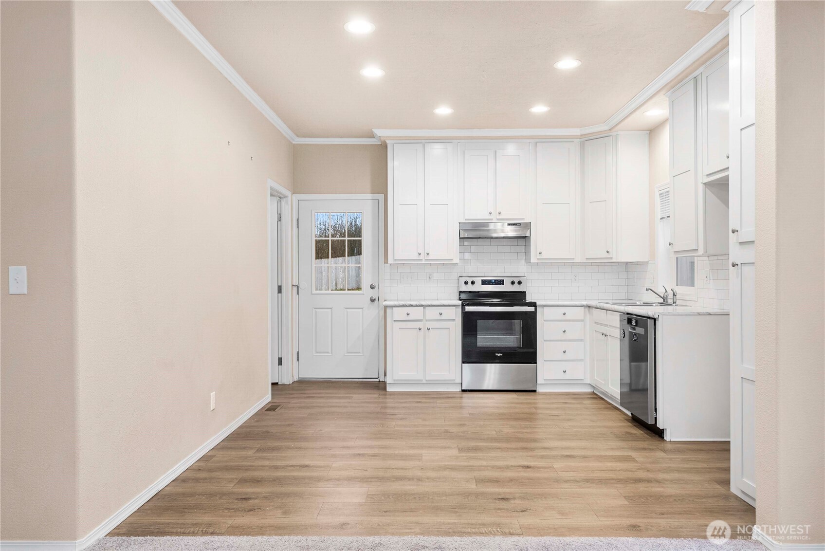 52 Southeast Spring Street Chehalis, WA 98532 - Photo 5 of 40 a kitchen with a refrigerator stove and white cabinets