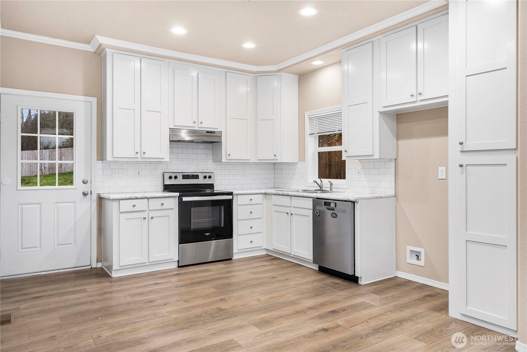 52 Southeast Spring Street Chehalis, WA 98532 - Photo 6 of 40 a kitchen with a refrigerator stove top oven and cabinets