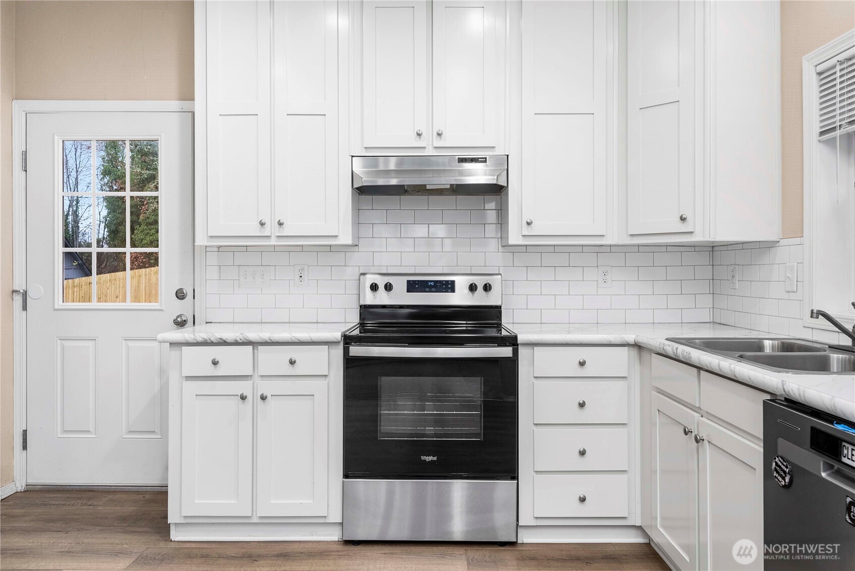 52 Southeast Spring Street Chehalis, WA 98532 - Photo 7 of 40 a kitchen with granite countertop white cabinets and stainless steel appliances