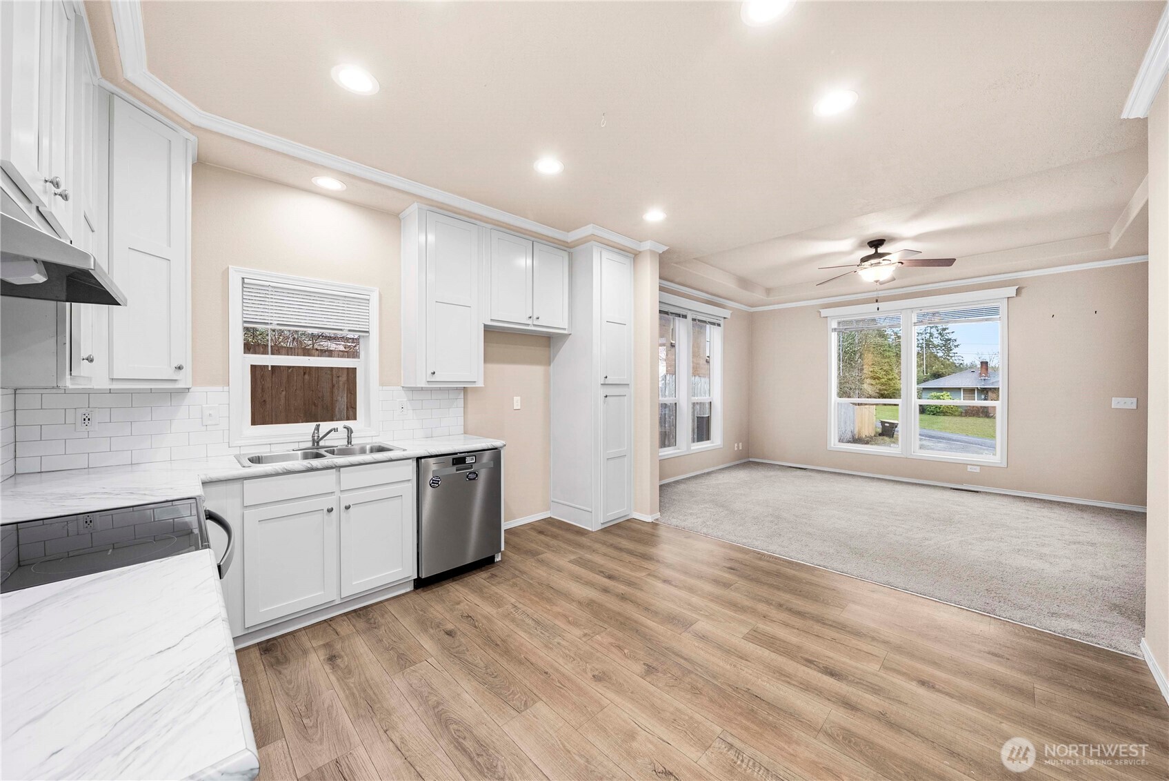 52 Southeast Spring Street Chehalis, WA 98532 - Photo 9 of 40 a large kitchen with kitchen island a stove a sink dishwasher and a refrigerator with wooden floor