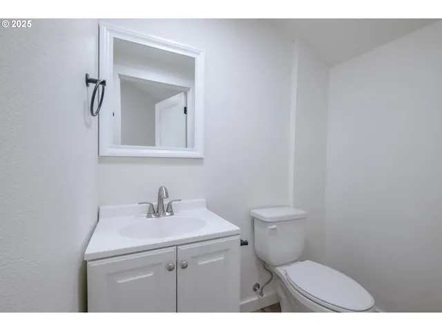a bathroom with a sink a toilet and mirror