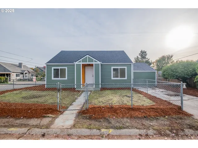 a view of a yard in front of a house with a patio