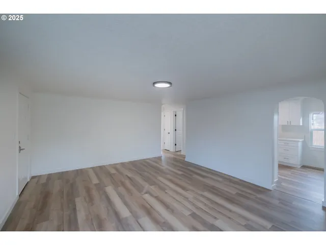 a view of an empty room and wooden floor