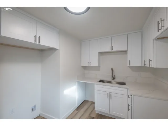 a kitchen with cabinets appliances and a sink
