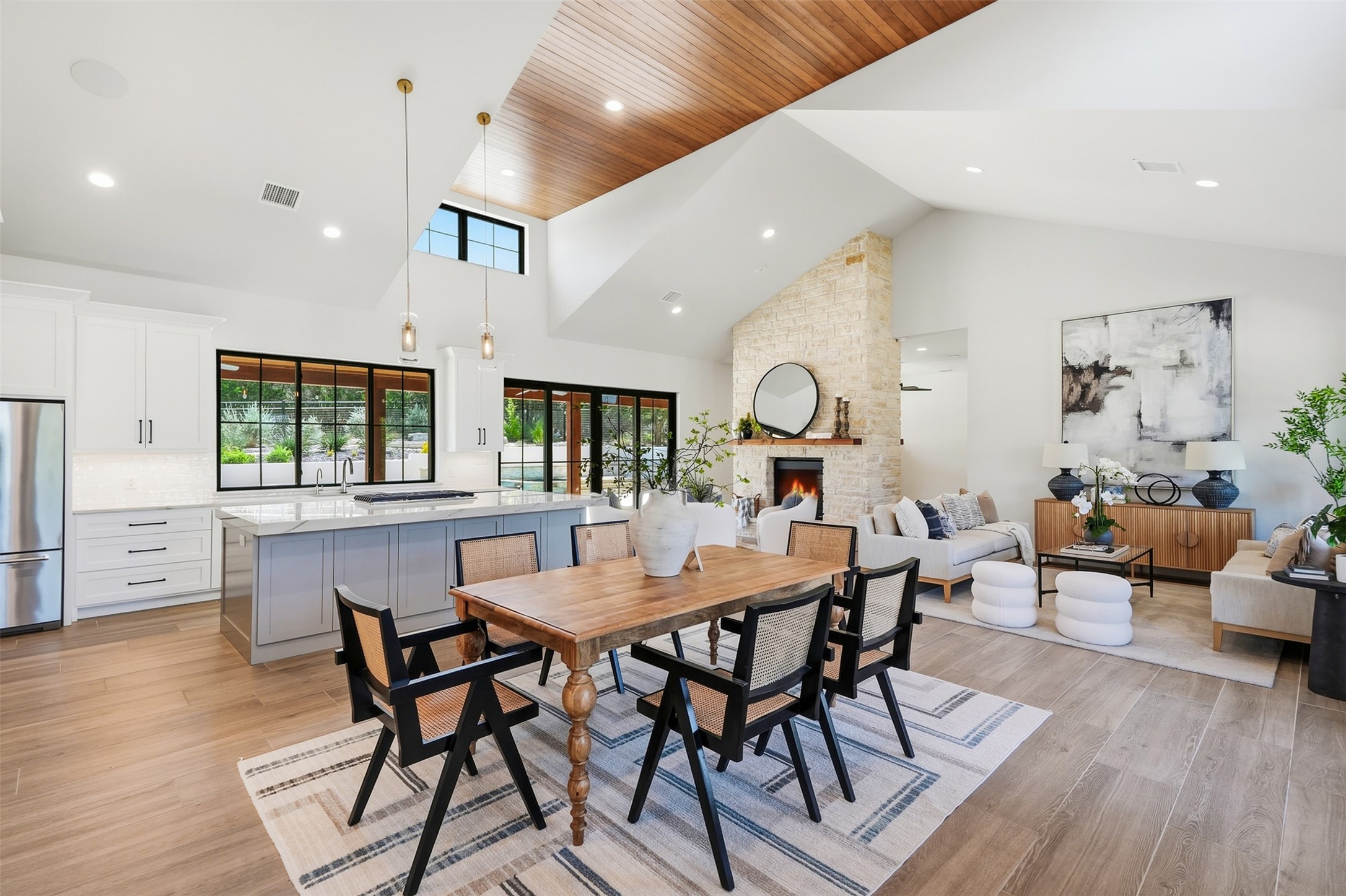 27619 Sunset Loop Garden Ridge, TX 78266 - Photo 2 of 39 Gleaming wood-paneled ceilings vault over a seamless open-concept living and dining layout.