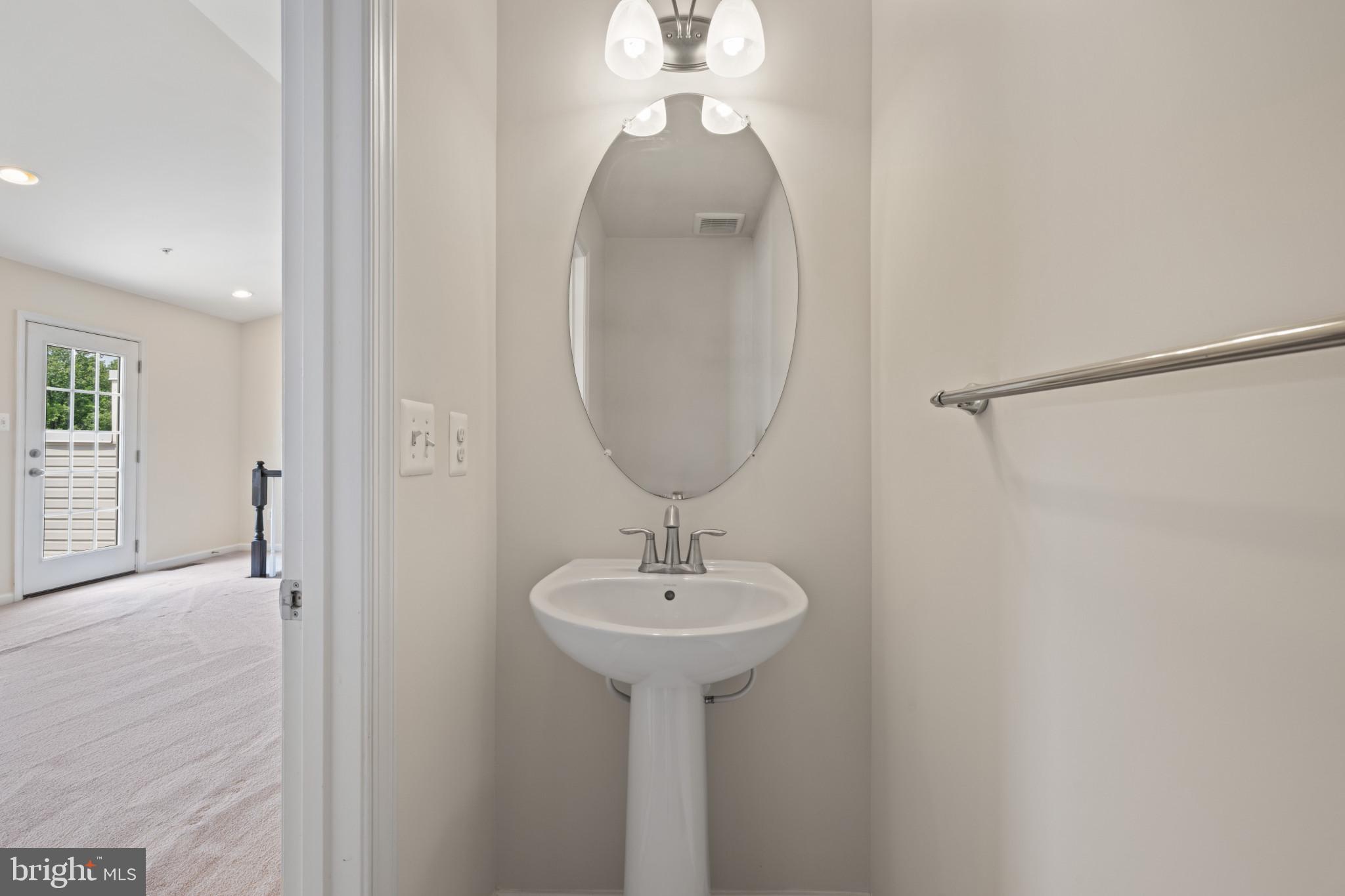 7062 Foxton Way Hanover, MD 21076 - Photo 30 of 41 a bathroom with a sink and a mirror