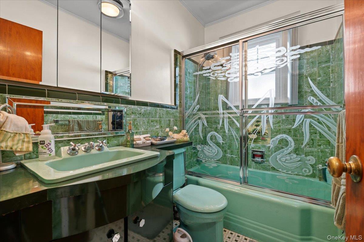 183-41 Dalny Road Queens, NY 11432 - Photo 11 of 31 a bathroom with a sink mirror vanity and toilet
