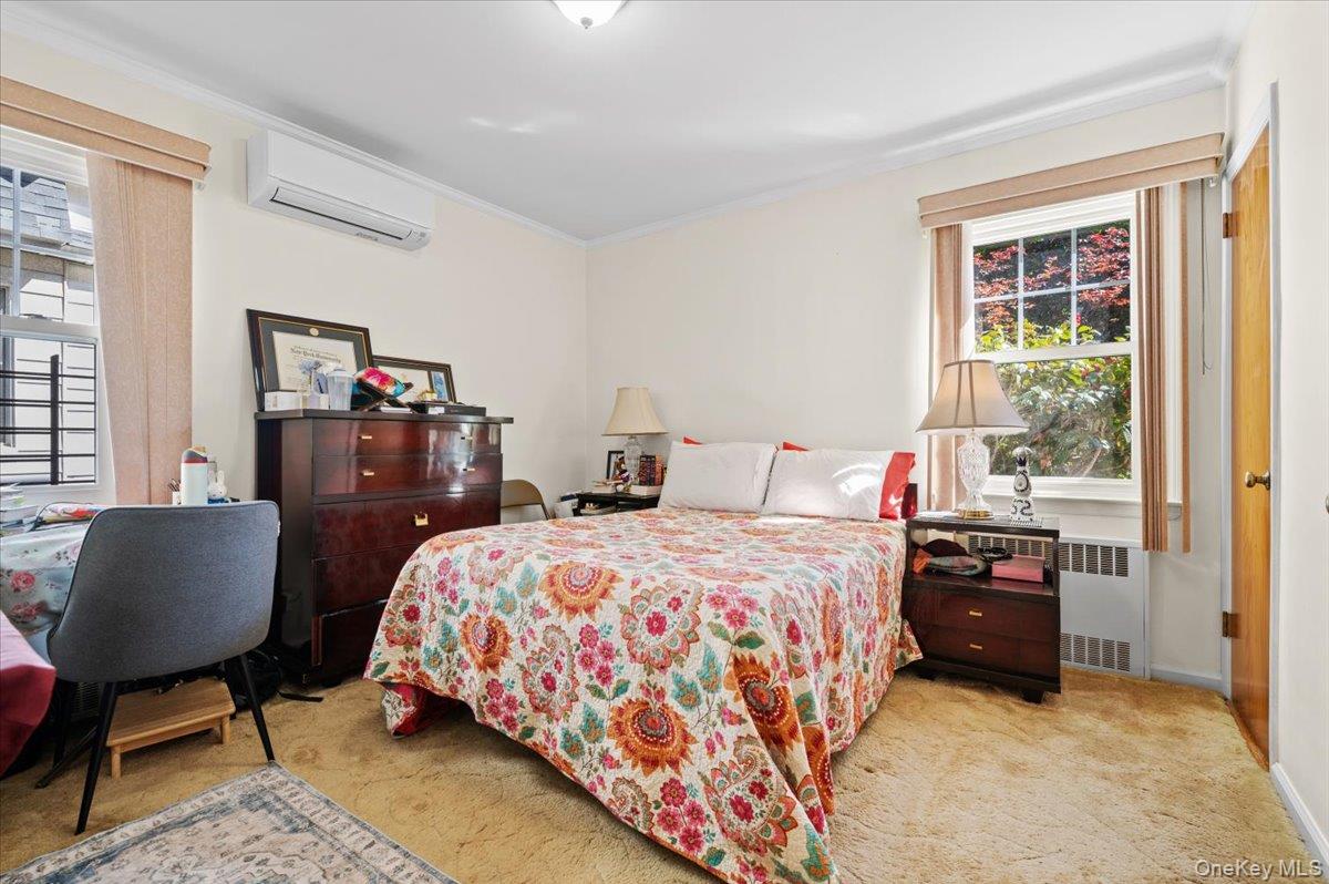 183-41 Dalny Road Queens, NY 11432 - Photo 13 of 31 a bedroom with bed and window