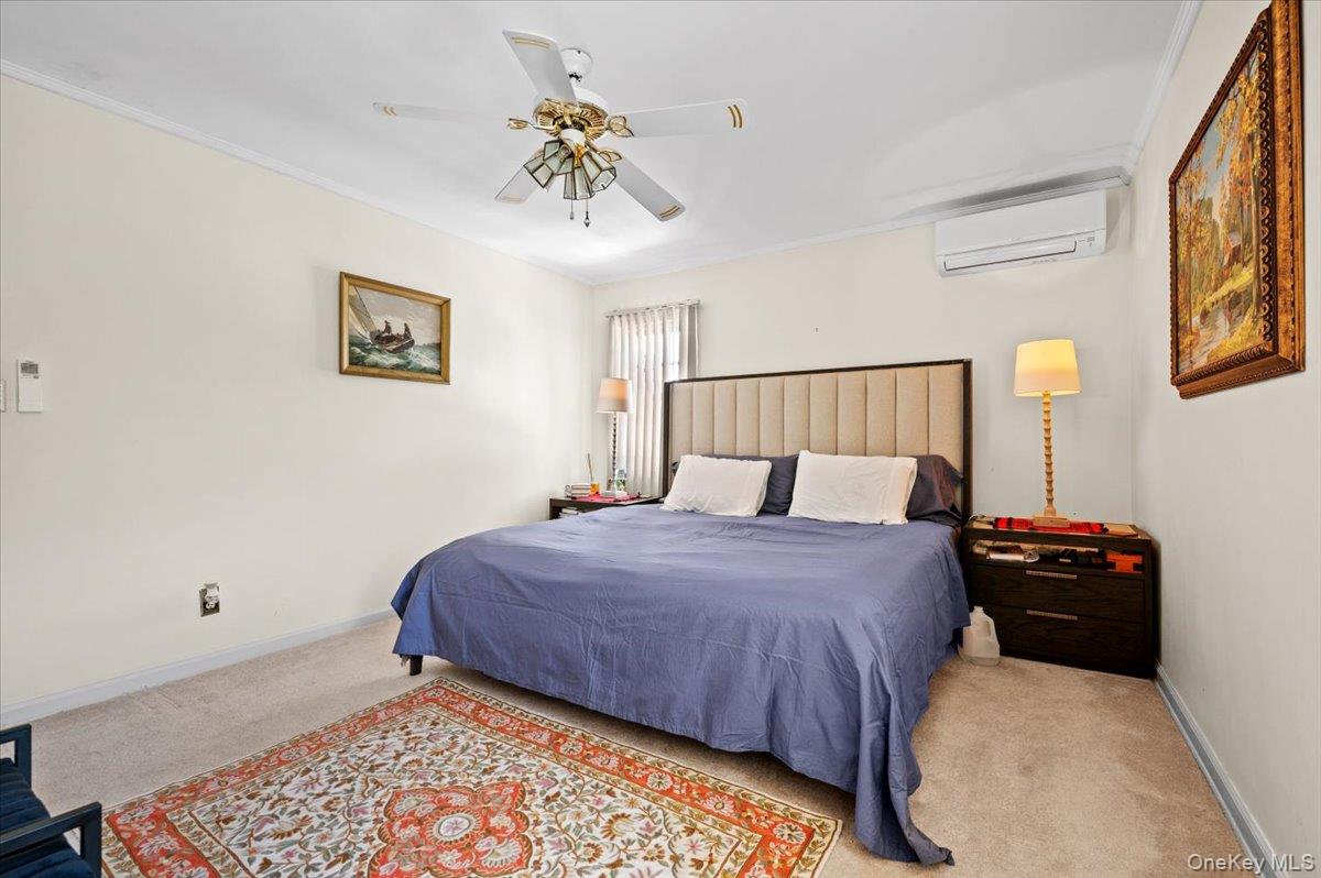 183-41 Dalny Road Queens, NY 11432 - Photo 19 of 31 a bedroom with a bed and a chandelier