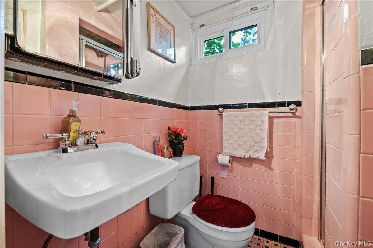 183-41 Dalny Road Queens, NY 11432 - Photo 21 of 31 a bathroom with a sink a toilet and a mirror