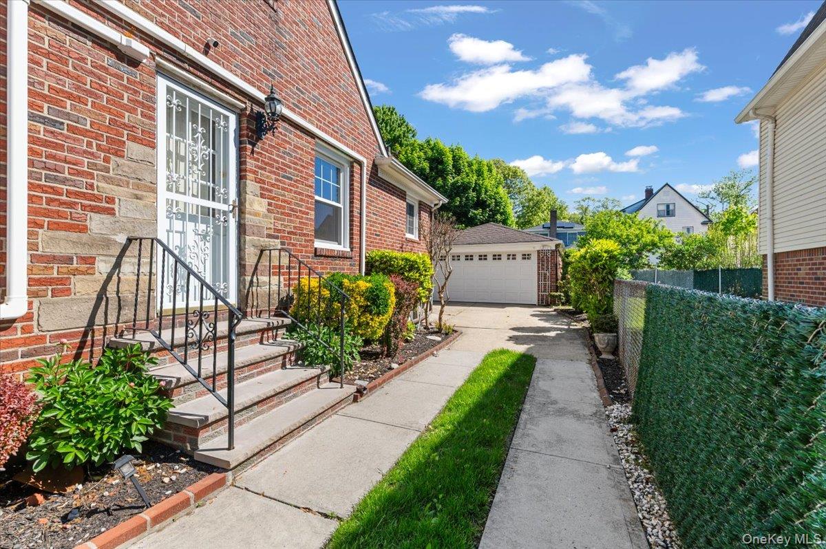 183-41 Dalny Road Queens, NY 11432 - Photo 25 of 31 a front view of a house with a yard and potted plants