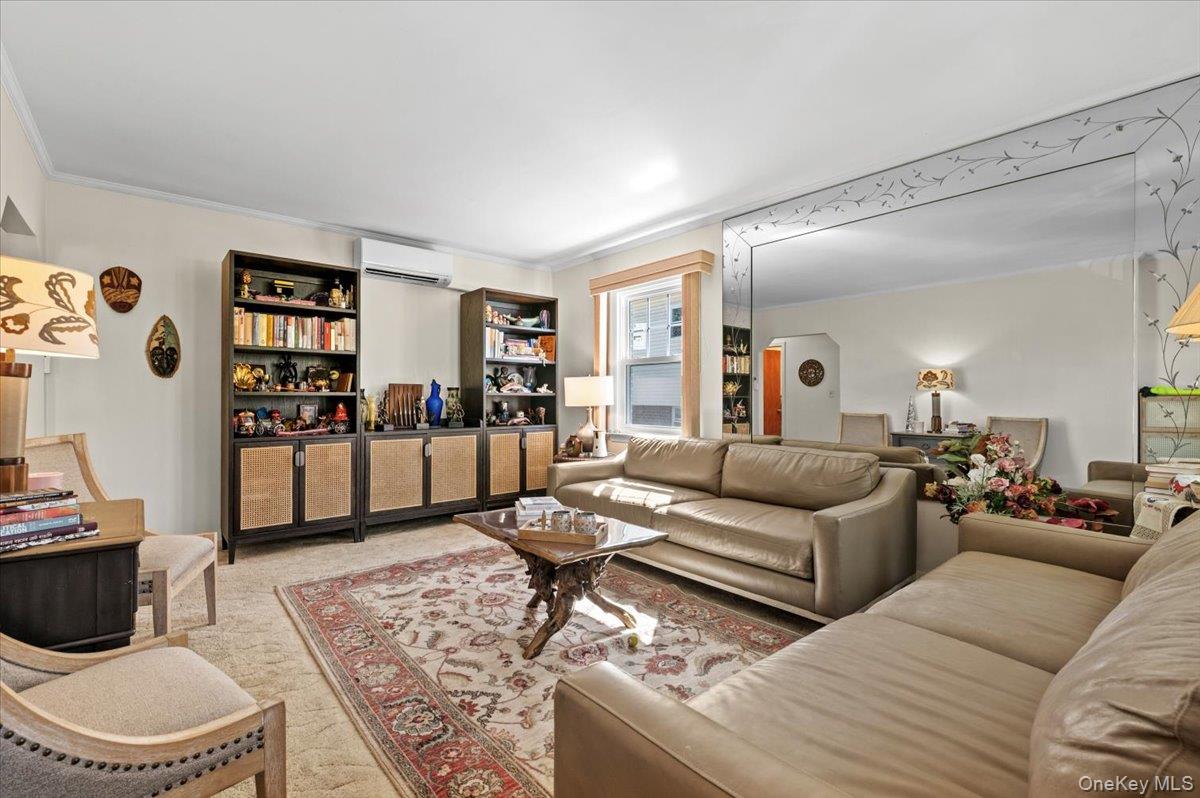 183-41 Dalny Road Queens, NY 11432 - Photo 3 of 31 a living room with furniture and a book shelf
