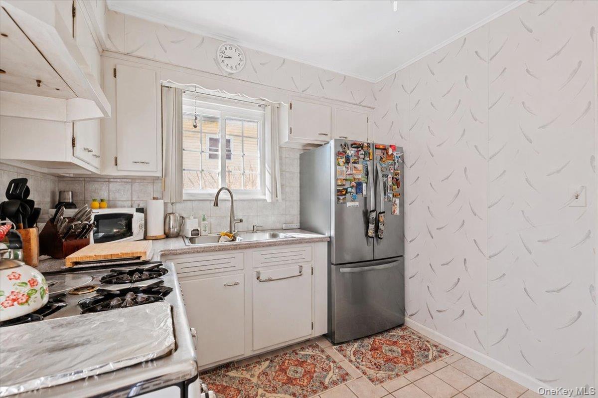 183-41 Dalny Road Queens, NY 11432 - Photo 8 of 31 a kitchen with stainless steel appliances granite countertop a refrigerator and a sink