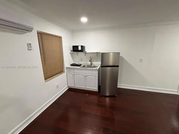 a kitchen with a refrigerator sink and cabinets