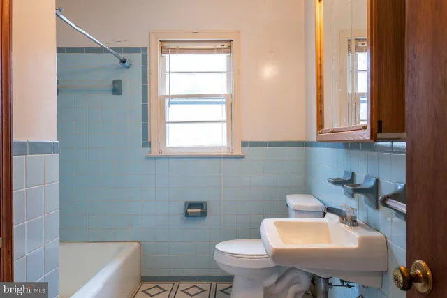 a bathroom with a sink a toilet and bathtub