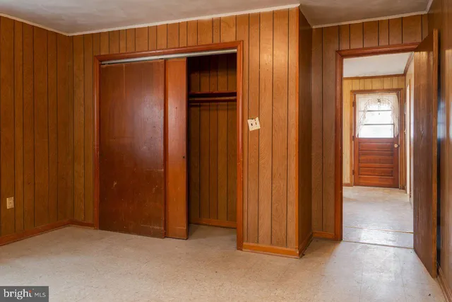 an empty room with closet area