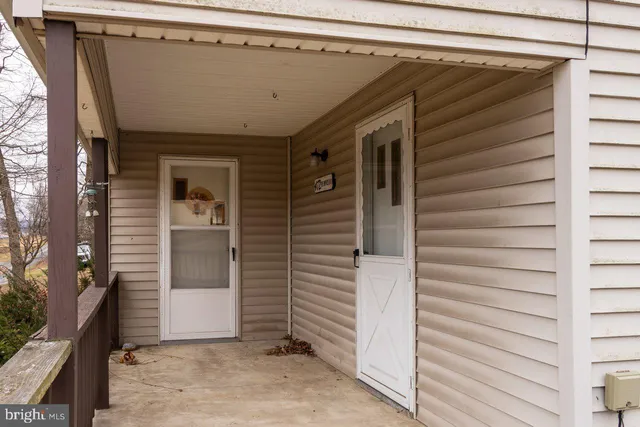 a view of front door and deck of the house