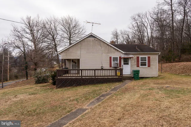 a view of a house with a yard and trees