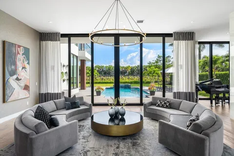 a living room with furniture and a mirror