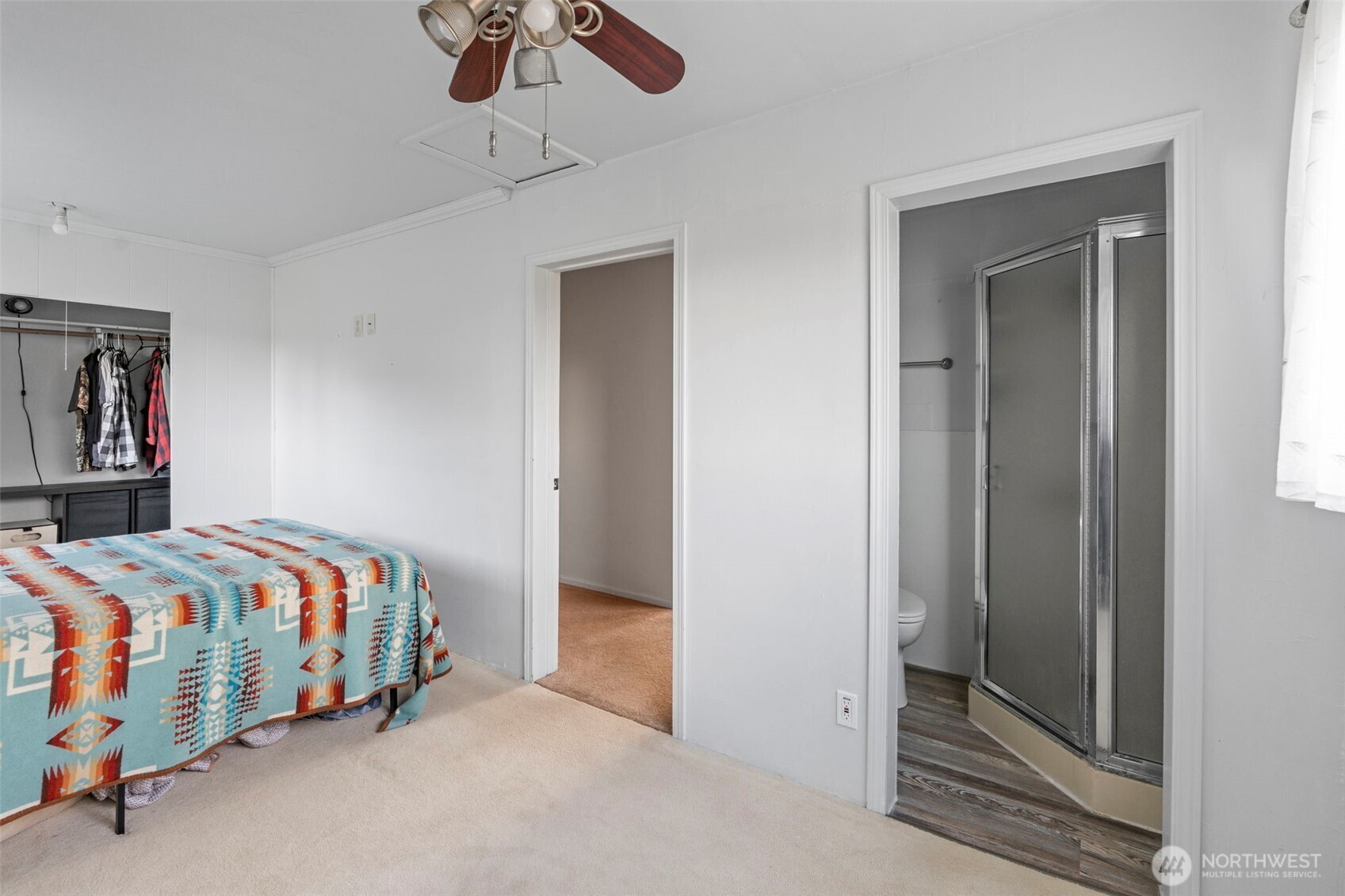 450 Hawkins Road Winlock, WA 98596 - Photo 16 of 40 a bedroom with a bed and a chandelier