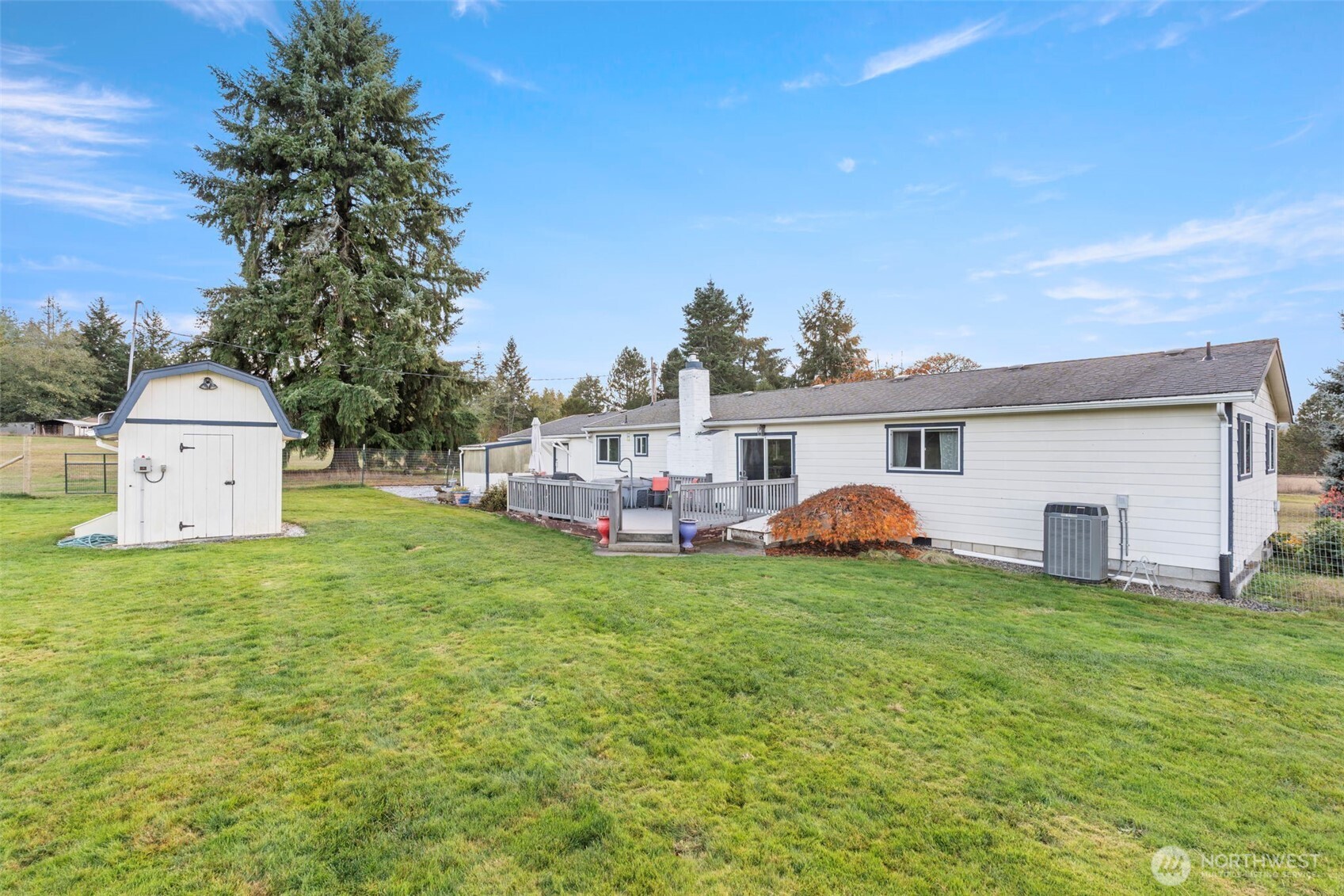 450 Hawkins Road Winlock, WA 98596 - Photo 24 of 40 a view of a white house in front of a big yard with plants and large tree