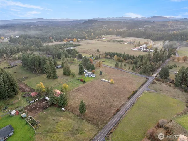 an aerial view of a house with a yard