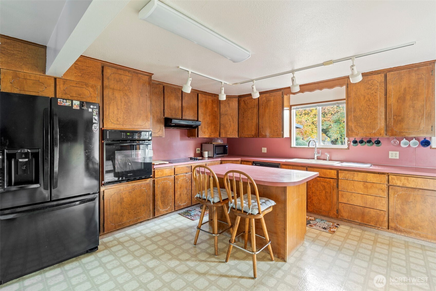 450 Hawkins Road Winlock, WA 98596 - Photo 9 of 40 a kitchen with stainless steel appliances granite countertop a table chairs sink refrigerator and microwave
