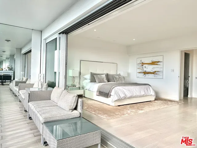 a bedroom with a large bed and a couch