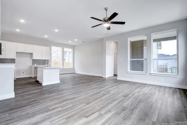 a view of a kitchen with wooden floor and a window