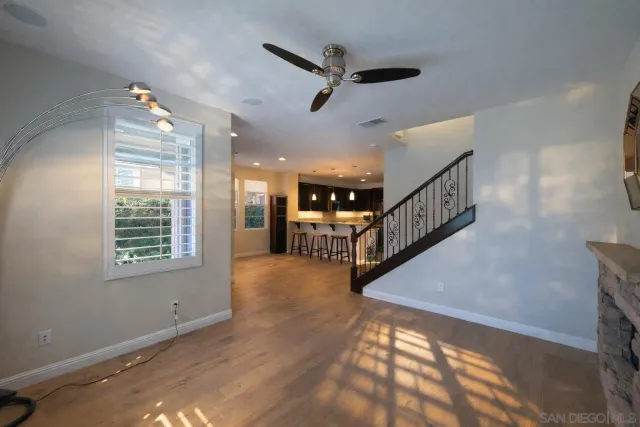 a view of an entryway wooden floor and a window