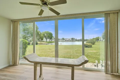 a view of a room with a floor to ceiling window and an outdoor view