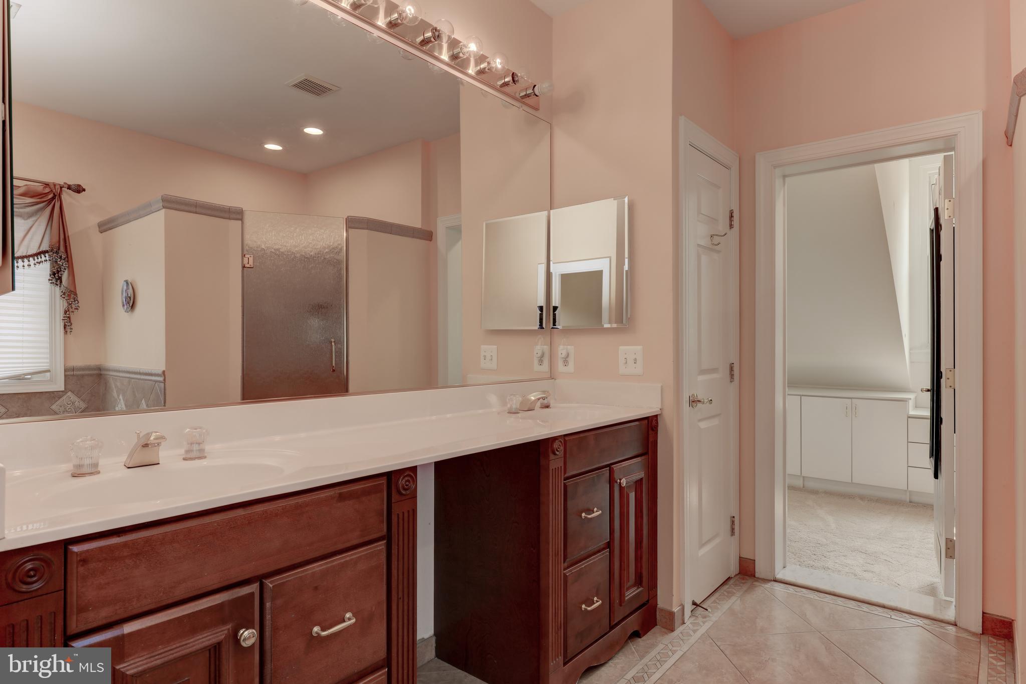 7394 Spring Summit Road Springfield, VA 22150 - Photo 33 of 69 double sink with vanity seat are and linen in prim