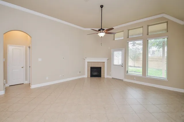 a view of empty room with fireplace and fan