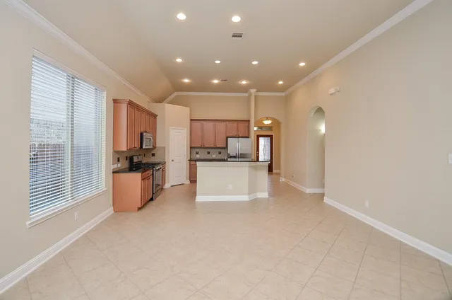 a view of kitchen with refrigerator and window