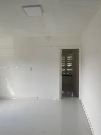 a view of an empty room and fire place