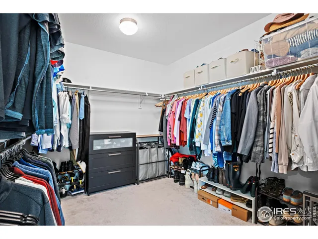 a living room with a flat screen tv and a refrigerator