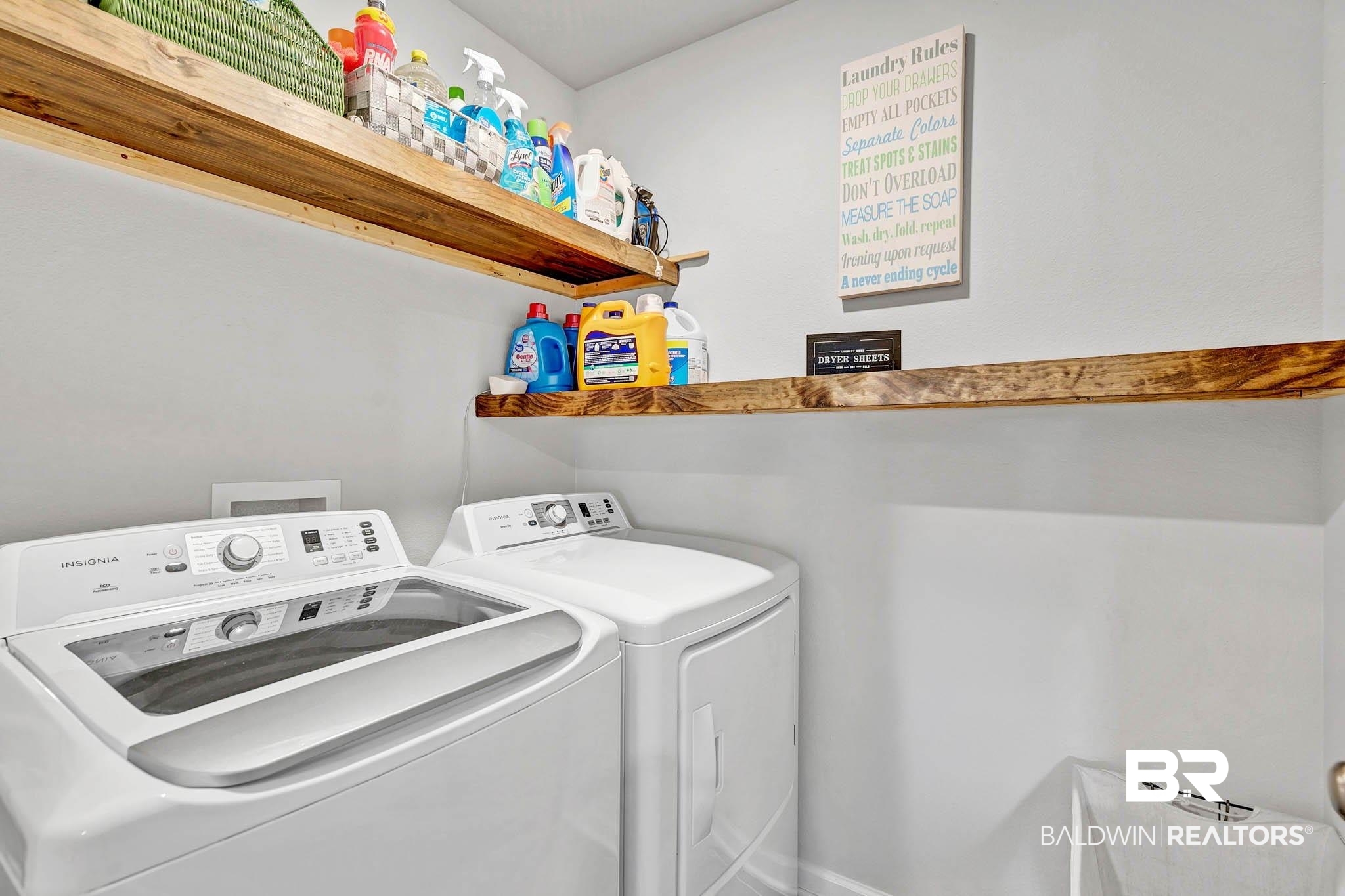 17217 REFLECTION Street Loxley, AL 36551 - Photo 27 of 83 Laundry room with washing machine and clothes dryer and wooden shelving.