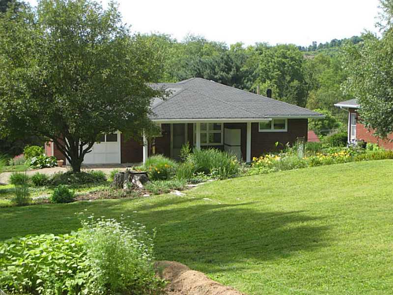 2833 Italy Road Export, PA 15632 - Photo 1 of 23 Exterior Back. View of the back of the home offering a covered rear porch, lush landscaping, two lots and an attached garage!