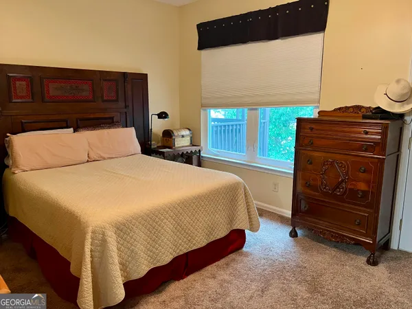 a bedroom with a bed and dresser